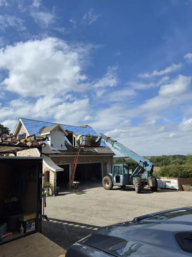 Roofing crew working on a garage dormer addition