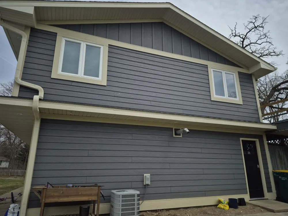 Two-story home with gray lap siding and white window trim
